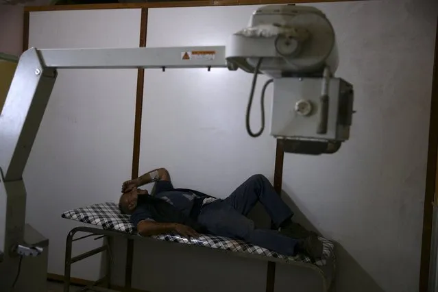 An injured man rests inside a field hospital, after what activists said was shelling by forces loyal to Syria's President Bashar al-Assad in the Douma neighborhood of Damascus, Syria December 2, 2015. (Photo by Bassam Khabieh/Reuters)