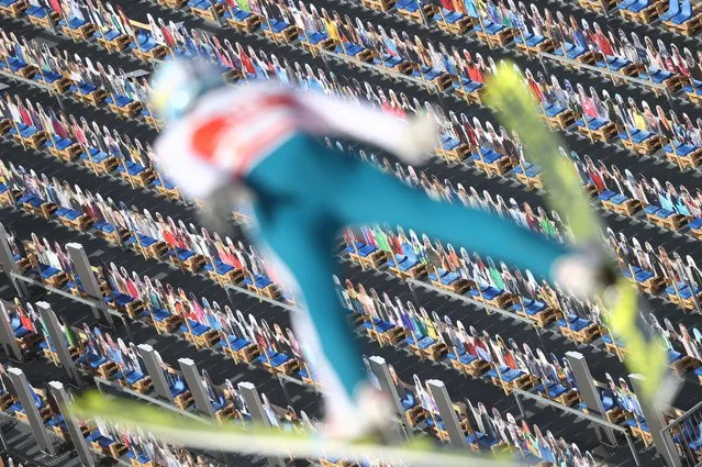 Cardboard spectators are seen as Finland's Jarkko Maatta jumps during the Men's Ski Jumping Training at FIS Nordic World Ski Championships in Oberstdorf, Germany on February 24, 2021. (Photo by Kai Pfaffenbach/Reuters)