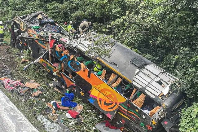 A handout photo made available by Juliano Neitzke that shows a tourist bus that lost control on a highway near the Guaratuba municipality, Parana state, Brazil, 25 January 2021. At least 19 people died and another 27 were injured, nine of them seriously, in a traffic accident with a bus that occurred on Monday on the coast of Parana, a state in southern Brazil bordering Paraguay and Argentina, authorities reported. The Federal Highway Police in Parana informed EFE that the tourist bus driver lost control of the vehicle in a sharp curve at kilometer 668 of the BR-376 national highway, in the jurisdiction of the municipality of Guaratuba, 131 kilometers from Curitiba, the regional capital. (Photo by Juliano Neitzke/EPA/EFE)