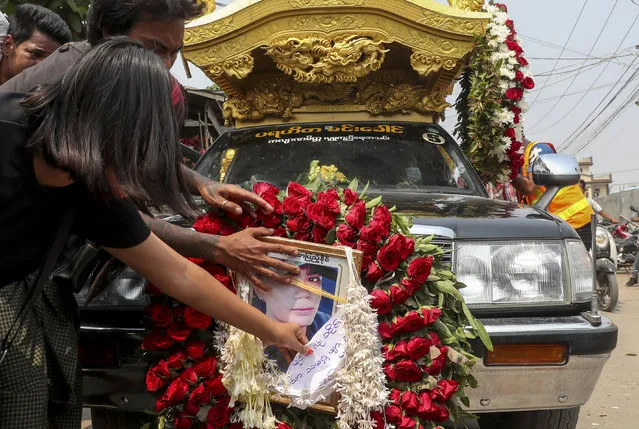 A hearse carrying the body of Saw Pyae Naing is driven in Mandalay, Myanmar, Sunday, March 14, 2021. Saw Pyae Naing, a 21-year old anti-coup protester was shot and killed by Myanmar security forces during a demonstration on Saturday, according to his family. (Photo by AP Photo/Stringer)