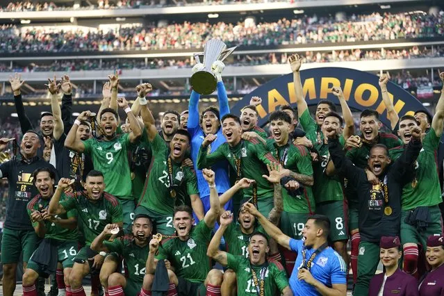 Mexico players celebrate with the winner's trophy after beating Panama 1-0 after the CONCACAF Gold Cup final soccer match Sunday, July 16, 2023, in Inglewood, Calif. (Photo by Ashley Landis/AP Photo)