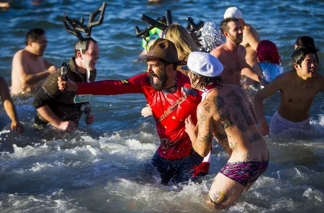 Participants take part in the 96th annual New Year's Day Polar Bear Swim in English Bay, Vancouver, British Columbia January 1, 2016. (Photo by Ben Nelms/Reuters)