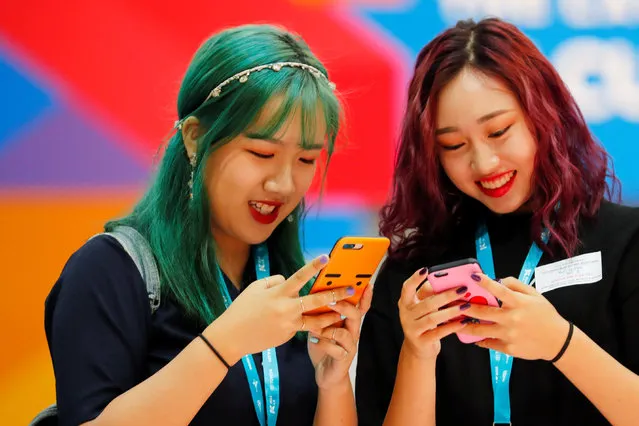 Attendees look at their phones as they participate at KCON USA, California on August 11, 2018. Attendance at this year's event in Los Angeles, which has one of the largest Korean diaspora communities, was expected to exceed the 85,000 who attended last year, organizers said. (Photo by Mike Blake/Reuters)