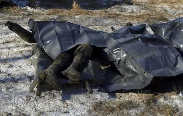 Bodies of Ukrainian soldiers killed in Debaltseve are pictured on stretchers at a military camp in Artemivsk, February 18, 2015. (Photo by Oleksandr Klymenko/Reuters)