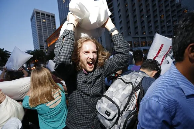 A participant swings his pillow during The Great San Francisco Valentine's Day Pillow Fight, in San Francisco, February 14, 2015. Hundreds of people converged on Justin Herman Plaza to belt one another with pillows in the annual unsanctioned event spread through social media. (Photo by Stephen Lam/Reuters)
