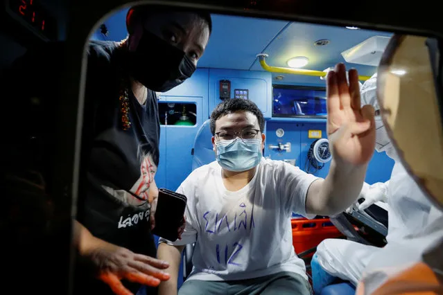 Pro-democracy activist Parit “Penguin” Chiwarak makes the three-finger salute as he is released from the Bangkok Remand Prison in Bangkok on May 11, 2021, after he was granted bail amid deteriorating health following a hunger strike that lasted more than 50 days. (Photo by Jorge Silva/Reuters)