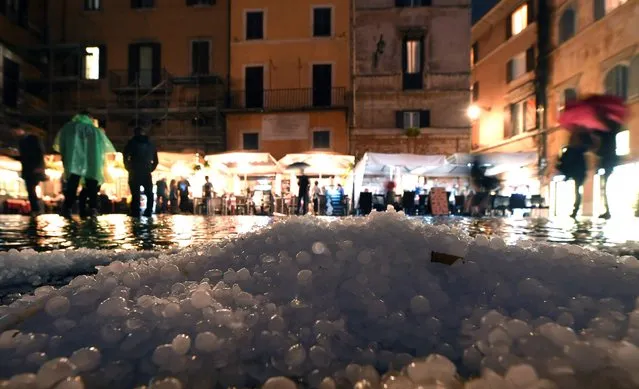Hail covers the street in downtown Rome during a hailstorm on October 21, 2018. (Photo by Tiziana Fabi/AFP Photo) 