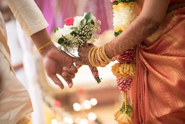 South indian ceylonese couple linking pinky fingers on Wedding Day. (Photo by Andy Lim/Rex Features/Shutterstock)