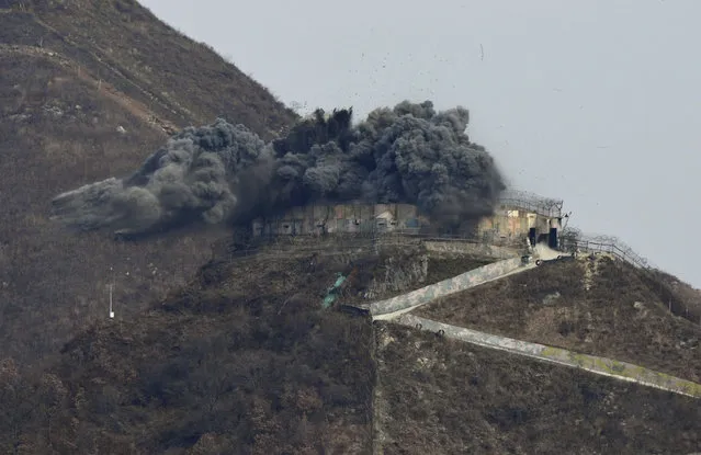 This general view shows an explosion as part of the dismantling of a South Korean guard post in the Demilitarized Zone dividing the two Koreas in Cheorwon on Thursday, November 15, 2018.  (Photo by Jung Yeon-je/Pool Photo via AP Photo)