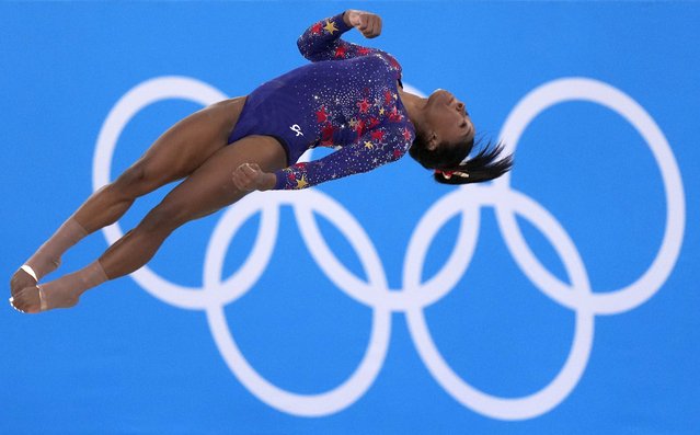 Simone Biles, of United States, performs her floor exercise routine during the women's artistic gymnastic qualifications at the 2020 Summer Olympics, Sunday, July 25, 2021, in Tokyo. (Photo by Gregory Bull/AP Photo)