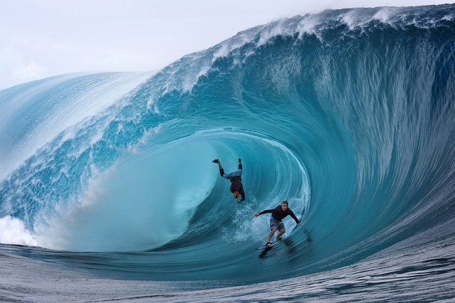 US Garrett McNamara (L) and US Mark Healey (R) compete during a free session of surf tow in, in the southern Pacific ocean island of Tahiti, French Polynesia, on June 1, 2013 in Teahupoo. (Photo by Gregory Boissy/AFP Photo)
