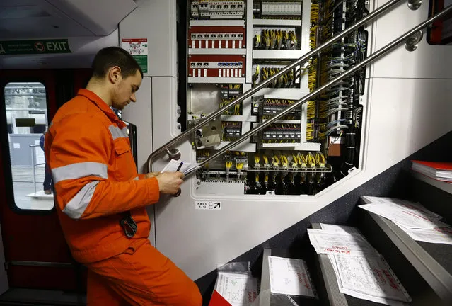 An employee works on an electric train assembly line  at the “Stadler Minsk” plant in Fanipol, Belarus February 10, 2016. (Photo by Vasily Fedosenko/Reuters)