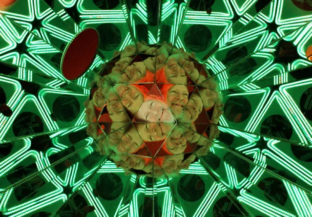 Local artist Tom Chouteau looks through the Hands In Scope kaleidoscope which is part of his Kaleidoscopia display at the German American Heritage Center in Davenport, Iowa, Wednesday, February 11, 2015. (Photo by Kevin E. Schmidt/AP Photo/The Quad City Times)