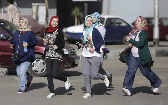 Young Egyptian women run in the Mohandiseen district in Cairo, Egypt, Friday, April 10, 2015. Runners take advantage of Cairo's empty streets during the Muslim holy day of Friday, when traffic is sparse. There are precious few spaces to run and private clubs that are suitable for running are prohibitively expensive for many. (Photo by Amr Nabil/AP Photo)