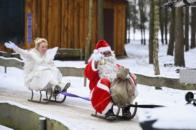 People dressed as Santa Claus and an angel ride on sleds, during their annual meeting at the animal park Germendorf, in Oranienburg, Germany on December 3, 2023. (Photo by Annegret Hilse/Reuters)