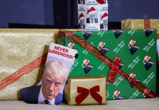 A Christmas boot and gifts featuring the image of Republican presidential candidate and former U.S. President Donald Trump are displayed ahead of Trump's campaign event in Waterloo, Iowa on December 19, 2023. (Photo by Scott Morgan/Reuters)