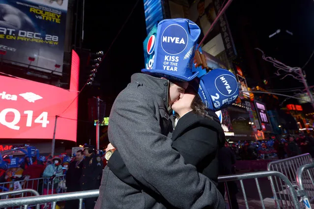 Zac Hihey surprises his girlfriend, Hannah Kanaan, with a proposal on the NIVEA Kiss Stage in Times Square on December 31, 2013 in New York City. (Photo by Michael Loccisano/Getty Images for Nivea)