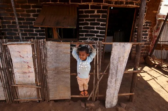 An Eritrean refugee girl plays in front of their shelter in Mai-Aini refugee camp near the Eritrean boarder in the Tigrai region in Ethiopia February 10 2016. Each month as many as 5,000 people flee Eritrea according to U.N. figures, estimates the Eritrean government disputes. The government puts the population at about 3.6 million, while other estimates suggest it could be almost double that. (Photo by Tiksa Negeri/Reuters)