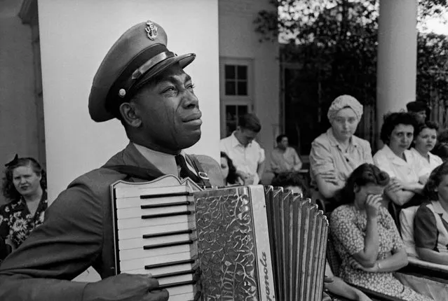 Navy CPO Graham Jackson with tears of grief streaming down his cheeks as he plays “Goin' Home” on the accordion while Pres. Franklin D. Roosevelt's body is carried from the Warm Springs Foundation where he died suddenly on April 12, of a stroke; April 13, 1945. (Photo by Ed Clark/The LIFE Picture Collection/Getty Images)