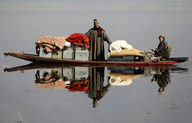 Kashmiris transport their belongings to a safer place after their houses were destroyed by a fire at Dhobi Ghat, on the outskirts of Srinagar December 30, 2013. At least 14 residential houses were gutted in the fire on Sunday night, according to residents. There were no reports of casualties in the fire, officials said. (Photo by Danish Ismail/Reuters)