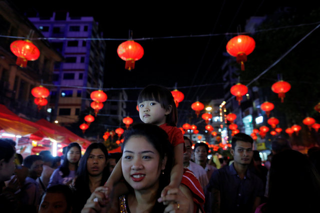 A girl sits on her mother's shoulders as they visit the Chinatown of Yangon, Myanmar, during the Chinese Lunar New Year, January 28, 2017. (Photo by Sheng Li/Reuters)