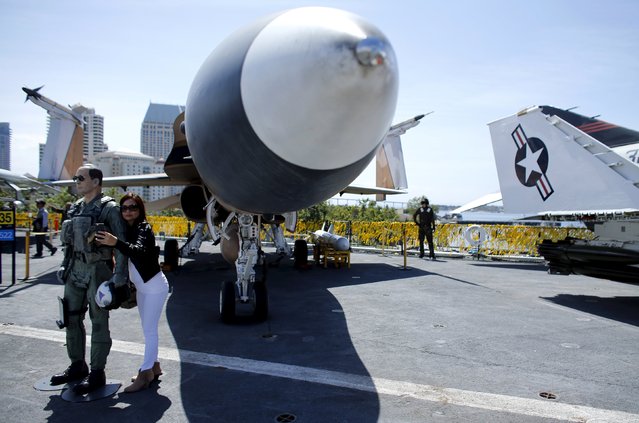 A visiting member of the Vietnamese community takes her own picture as she attends a ceremony on the flight deck of the USS Midway to commemorate the 40th anniversary of Operation Frequent Wind and the fall of Saigon in San Diego, California, United States April 26, 2015. (Photo by Mike Blake/Reuters)