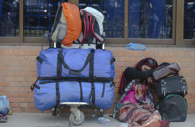 An Indian tourist sleeps at the Nepal International airport as she waits to be evacuated in Kathmandu, Nepal, Monday, April 27, 2015. (Photo by Manish Swarup/AP Photo)