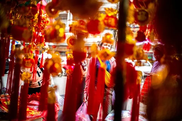 A woman shops ahead of Lunar New Year celebrations in Bangkok's Chinatown, Thailand, on February 8, 2024. (Photo by Athit Perawongmetha/Reuters)