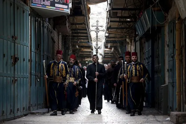 Members of the clergy take part in a Palm Sunday procession as they walk towards the Church of the Holy Sepulchre in Jerusalem's Old City March 20, 2016. (Photo by Amir Cohen/Reuters)