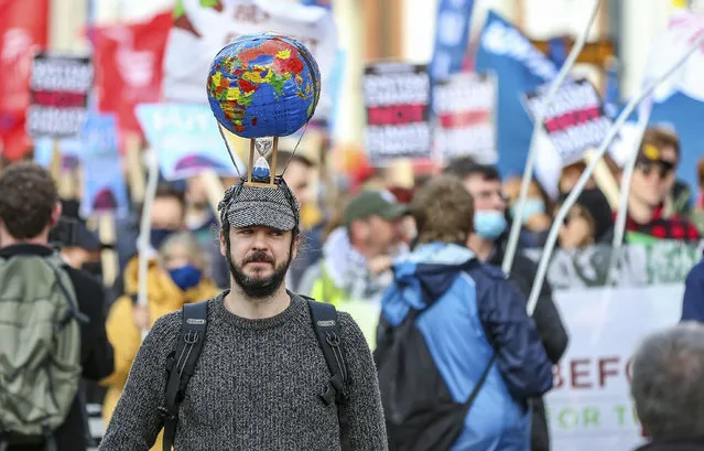 Climate activists attend a protest in Dublin, Ireland, Saturday, November 6, 2021. (Photo by Damien Storan/PA Wire via AP Photo)