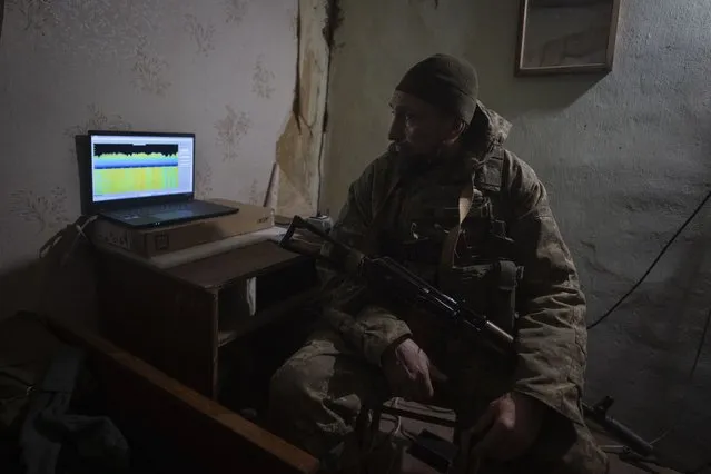 A Ukrainian soldier looks at a monitor of an electronic warfare system in a shelter to quell Russian drones at the front line, near Bakhmut, Donetsk region, Ukraine, Monday, January 29, 2024. Ukrainian forces are increasingly resorting to an age-old tactic – intelligence gleaned from radio intercepts – in a desperate effort to preserve their most vital resources. The painstaking work of eavesdropping is part of a larger effort to beef up and refine electronic warfare capabilities so that soldiers can be warned earlier of impending attacks, while having the battlefield intelligence needed to make their own strikes more deadly. (Photo by Efrem Lukatsky/AP Photo)