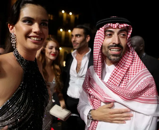 A handout picture released by the Red Sea Film Festival shows Portuguese model Sara Sampaio posing with the Festival Chairman Mohammed al-Turki on the red carpet during the opening ceremony of the 1st edition of the Red Sea film festival in the Saudi city of Jeddah, on December 6, 2021. (Photo by Patrick Baz/Red Sea Film Festival/AFP Photo)