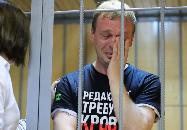 Ivan Golunov, a journalist who worked for the independent website Meduza, reacts in a cage in a court room in Moscow, Russia, Saturday, June 8, 2019. A prominent investigative journalist who was detained on drug-dealing charges in Russia is being taken to the hospital after complaining of feeling poorly in police custody. (Photo by Tatyana Makeyeva/Reuters)