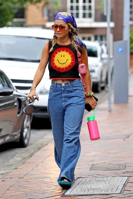 British singer-songwriter Rita Ora wears a crochet smiley face top, colourful bandanna and Prada crochet bag as she steps out with Taika Waititi in Double Bay, Australia on January 10, 2022. (Photo by KHAPGG/Backgrid USA)