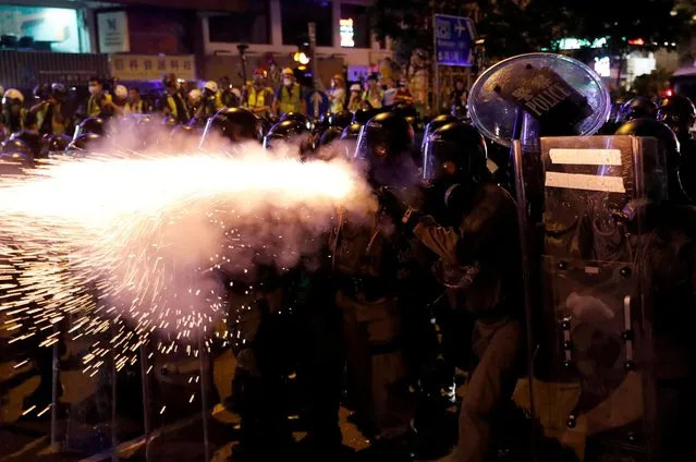 Riot police fire tear gas at anti-extradition demonstrators after a march to call for democratic reforms, in Hong Kong, China on July 21, 2019. (Photo by Tyrone Siu/Reuters)