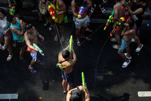Locals and tourists play with water as they celebrate the Songkran holiday which marks the Thai New Year in Bangkok, Thailand, on April 13, 2024. (Photo by Chalinee Thirasupa/Reuters)