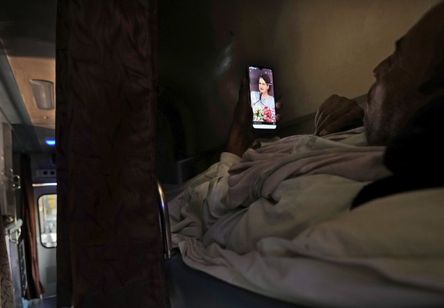 A passenger watches videos of Congress leader Priyanka Gandhi Vadra, while traveling in the Thirukkural Express, India, Sunday, April 21, 2024. (Photo by Manish Swarup/AP Photo)