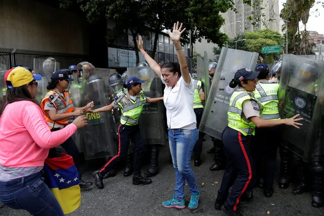 Gaby Arellano, deputy of the Venezuelan coalition of opposition parties (MUD), reacts after she was dosed with pepper spray during a rally against Venezuela's President Nicolas Maduro's government in Caracas, Venezuela April 1, 2017. (Photo by Marco Bello/Reuters)