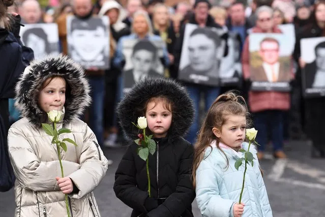 Children hold flowers as they retrace the steps of the original 1972 civil rights march in a walk of remembrance to mark the 50th anniversary of “Bloody Sunday” in Londonderry, Northern Ireland, January 30, 2022. (Photo by Clodagh Kilcoyne/Reuters)