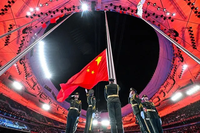 The Chinese national flag is raised during the closing ceremony of the Beijing 2022 Winter Olympic Games, at the National Stadium, known as the Bird's Nest, in Beijing, on February 20, 2022. (Photo by Anthony Wallace/AFP Photo)