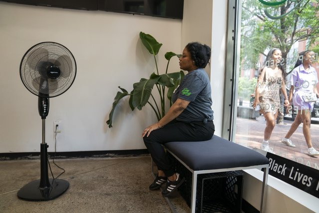 Keisha Campbell sits in front of a fan while waiting for customers to come into Turning Natural, a juice shop near Eastern Market, as a heat dome hits the Washington, DC area on June 18, 2024. (Photo by Carolyn Van Houten/The Washington Post)