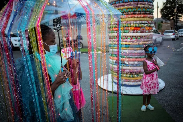 Costumed community members attend the annual Brixton Carnival of Lights in Johannesburg, South Africa, 06 February 2022. Members of the community organize the small but colorful carnival once a year to bring locals together and to parade through the streets. (Photo by Kim Ludbrook/EPA/EFE)