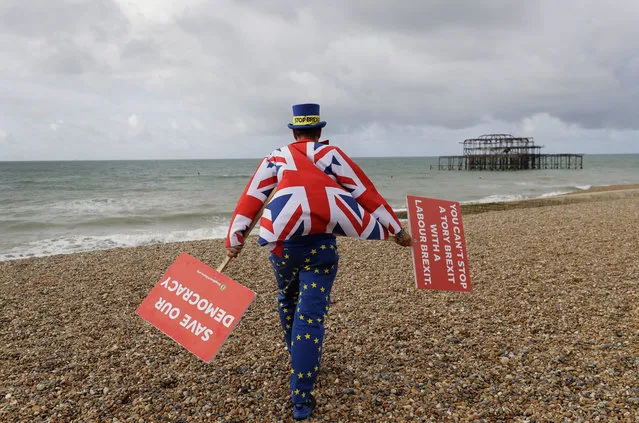 Anti Brexit campaigner Steve Bray walks on the beach to pose for a photograph during the Labour Party Conference at the Brighton Centre in Brighton, England, Monday, September 23, 2019. (Photo by Kirsty Wigglesworth/AP Photo)