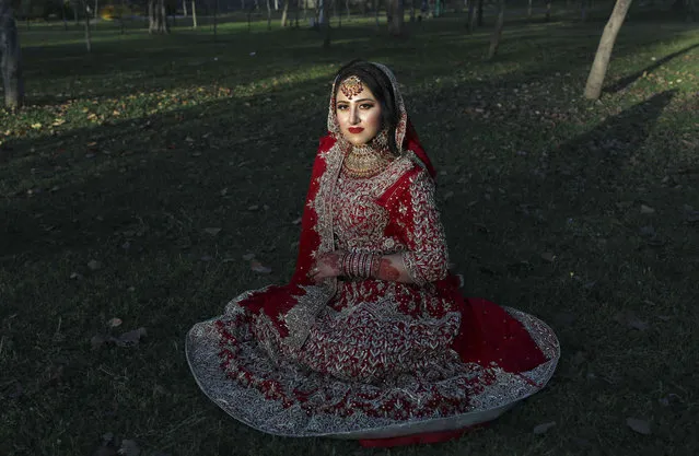 Hafiz Mohammad Awais, bride, poses for photograph, during her wedding ceremony in the park in Rawalpindi, Islamabad, Pakistan, Thursday, March 17, 2022. (Photo by Rahmat Gul/AP Photo)