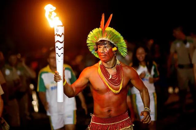 Raoni Vieira from Pataxo tribe takes part in the Olympic Flame torch relay in Porto Seguro, Bahia state, Brazil,  May 19, 2016. (Photo by Andre Mourao/Reuters/Courtesy of Rio2016)
