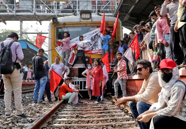 Demonstrators block a passenger train during a two-day long strike to protest against what they say are “anti-people” policies of the central government, in Kolkata, India, March 28, 2022. (Photo by Rupak De Chowdhuri/Reuters)