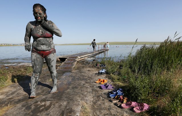 A woman covered with mineral-rich blue mud walks on the bank of Tus lake in Khakassia region, southwest of the Siberian city of Krasnoyarsk, Russia, July 18, 2015. (Photo by Ilya Naymushin/Reuters)