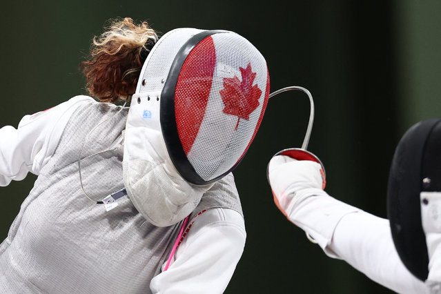 Canada's Eleanor Harvey (L) and China's Wang Yuting compete in the women's foil individual round of 32 bout during the Paris 2024 Olympic Games at the Grand Palais in Paris, on July 28, 2024. (Photo by Franck Fife/AFP Photo)