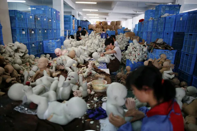 People work at Jinhua Partytime Latex Art and Crafts Factory in Jinhua, Zhejiang Province, China, May 25, 2016. (Photo by Aly Song/Reuters)