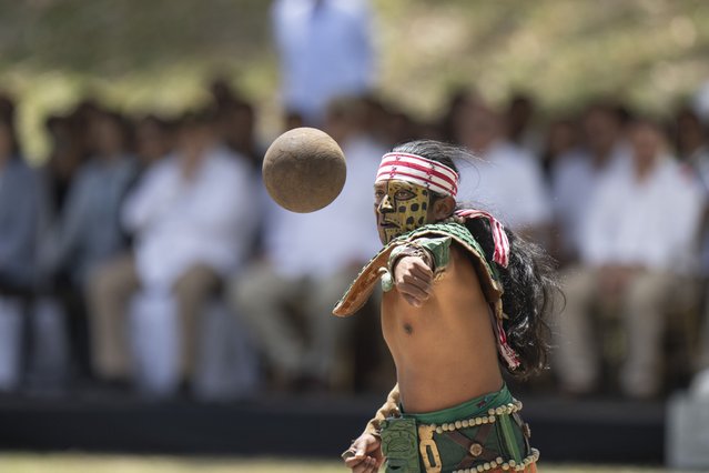 An artist performs as a player of “pelota Maya” during a visit by Taiwan's President Tsai Ing-wen and Guatemala's President Alejandro Giammattei, to the Mayan site Tikal, in Peten, Guatemala, Saturday, April 1, 2023. Tsai is in Guatemala for an official three-day visit. (Photo by Moises Castillo/AP Photo)